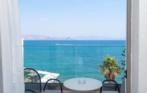 a dining room table with a view of the ocean at Triton Boutique Hotel in Kos
