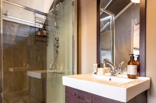 a bathroom with a sink and a shower at Abelana Safari Camp in Phalaborwa