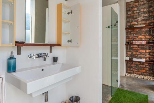 a bathroom with a white sink and a shower at Sunset-Loft in Cape Town