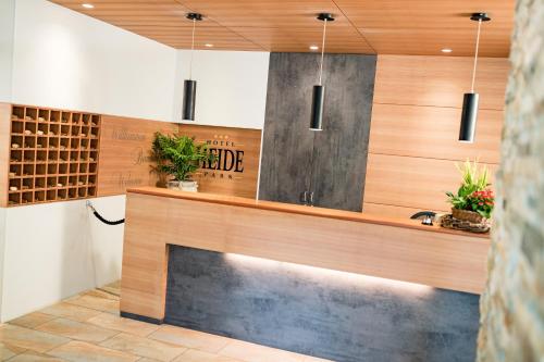 a kitchen with a counter and a sink in a room at Hotel Heide Park in Auer