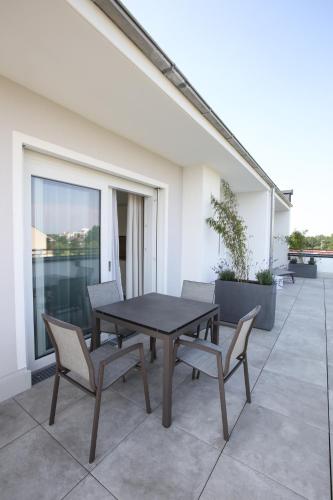 a black table and chairs on a patio at Appartementhotel Fidelio in Bad Füssing