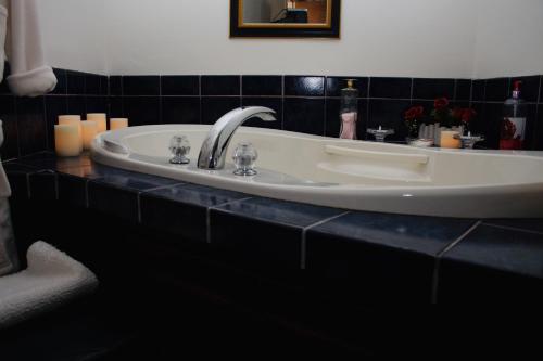 a bathroom with a sink with candles on a counter at Woodstock Inn Bed & Breakfast in Independence