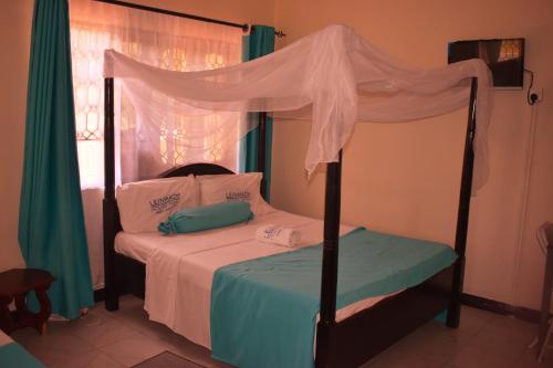 Posteľ alebo postele v izbe v ubytovaní Leinmach House Nyali