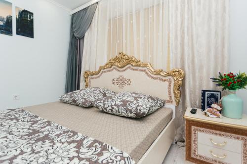 een slaapkamer met een bed met een gouden frame bij De LUXE apartments Centr 1 floor in Sumy