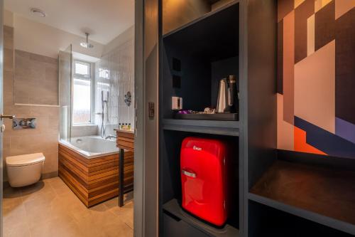 a bathroom with a red refrigerator in a room at Sligachan Hotel in Sconser