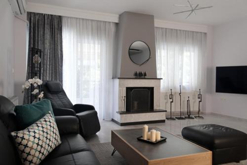 a living room with a couch and a fireplace at Dream Suite in Thessaloniki