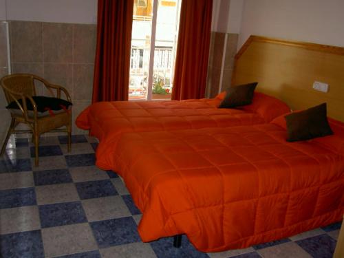 A bed or beds in a room at Hotel Libertador