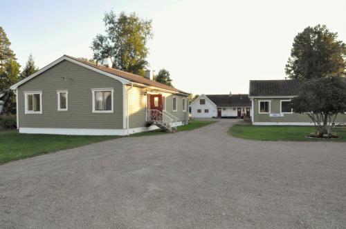 a house with a driveway in front of it at Råda Hotel in Hagfors