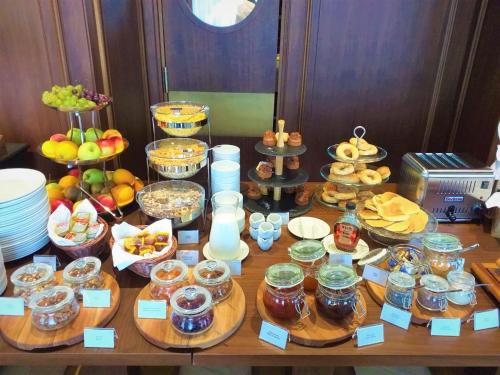 a table with many different types of food on it at Hotel Centar No.1 in Belgrade