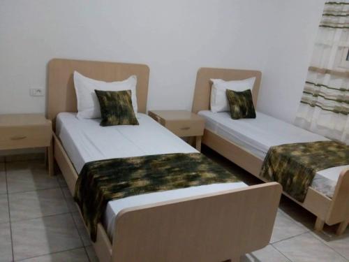 two beds in a hotel room withskirts at Villa de luxe avec piscine privée sans vis à vis à Djerba in Aghīr