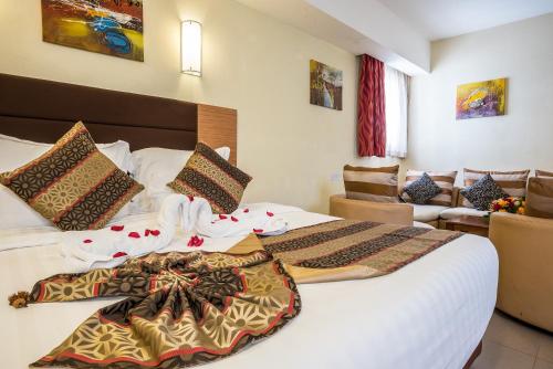 Кровать или кровати в номере PrideInn Hotel Mombasa City