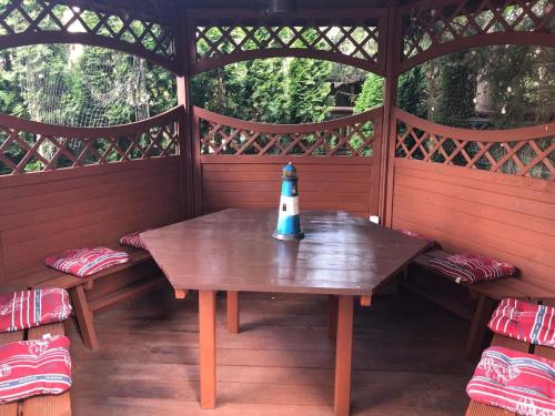 a table in a cabin with a lighthouse on it at Villa Papaj in Międzyzdroje