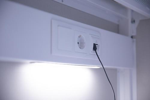 a lightswitch on a wall with a light on it at Dream in Santiago in Santiago de Compostela