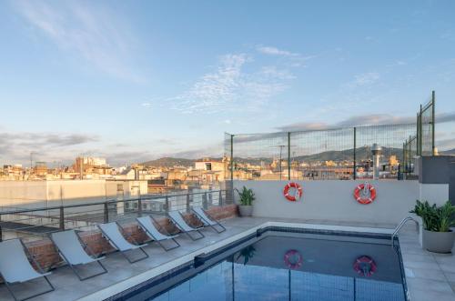 a swimming pool on the roof of a building at Silken Ramblas in Barcelona