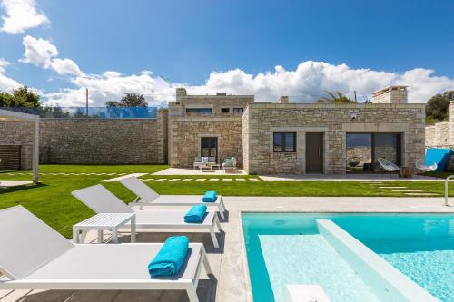 a villa with a swimming pool and a house at Thalmargia Villas, Ultimate Peace & Privacy, By ThinkVilla in Rethymno