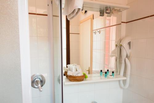 a bathroom with a shower with a mirror and a sink at Locanda Solagna in Quero