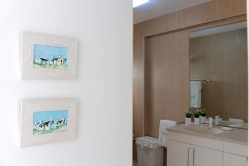 a bathroom with a sink and a mirror at The Artist Villa in Santa Cruz