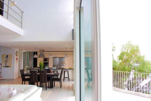 a living room and dining room with a view of a house at The Artist Villa in Santa Cruz