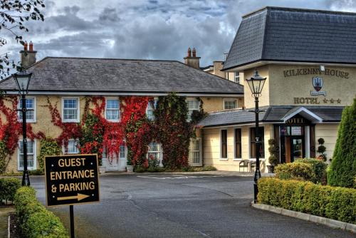 a guest entrance and parking sign in front of a hotel at Kilkenny House Boutique Hotel in Kilkenny