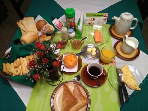 a table with a plate of breakfast food on it at Hotel Boggiani in Asuncion