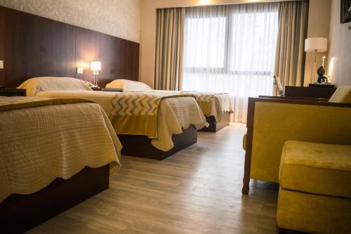 Säng eller sängar i ett rum på PLATINUM HOTEL CASINO