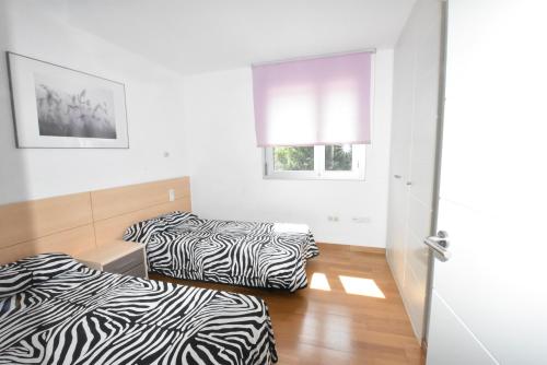 A bed or beds in a room at Apartamentos Boulevard Family