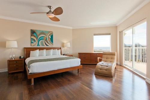 a bedroom with a large bed and a chair at Crystal Palms Beach Resort in St. Pete Beach