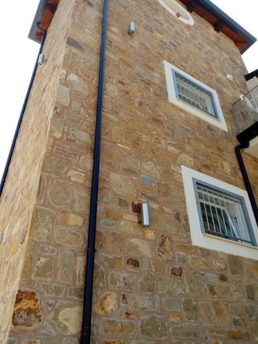 a brick building with two windows on it at LE TORRI DEL CILENTO in Santa Maria di Castellabate