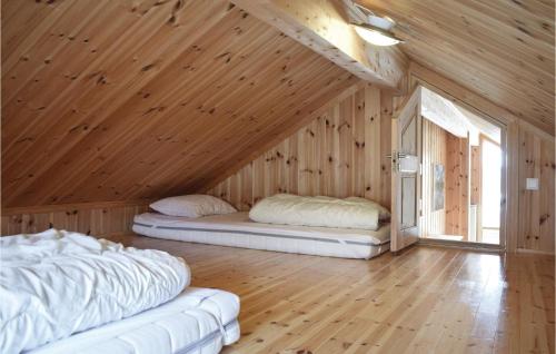 two beds in a room with a wooden ceiling at Awesome Home In Hemsedal With 3 Bedrooms And Wifi in Hemsedal