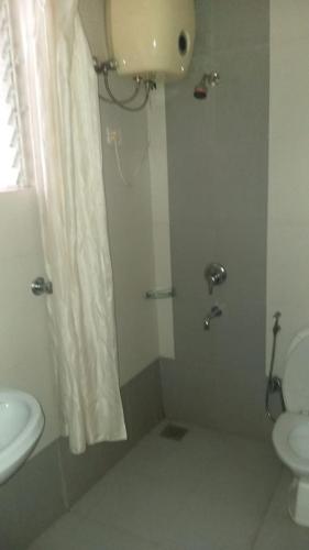 a bathroom with a sink and a toilet and a shower at River view apartments in Cavelossim