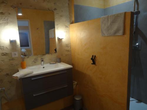 a bathroom with a sink and a mirror at La Fleury in Arles