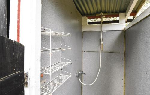 a bathroom with a metal rack on the wall at 2 Bedroom Amazing Home In Sjötofta in Sjötofta
