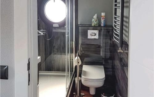 a small bathroom with a toilet and a window at Beautiful Ship-boat In Gteborg With 2 Bedrooms And Wifi in Gothenburg