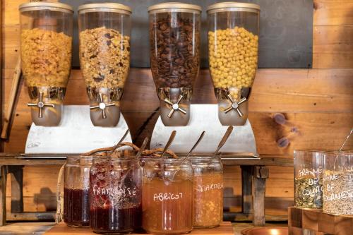 a display of different types of food in glass jars at Hôtel Les Balcons Village in Belle Plagne