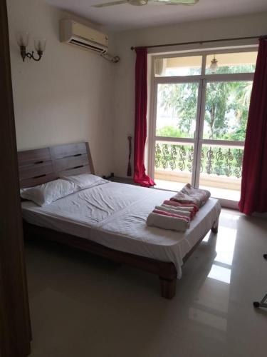 a bed in a room with a large window at River view apartments in Cavelossim