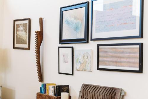 a group of framed pictures on a wall at Celia's Garden in Graton