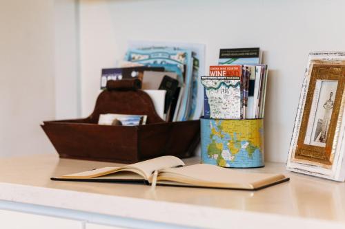 an open book on a table with a basket of books at Celia's Garden in Graton