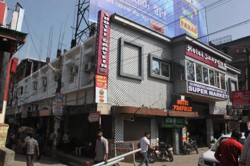 a building on a street with people walking in front of it at Hotel Saayein Residency in Siliguri
