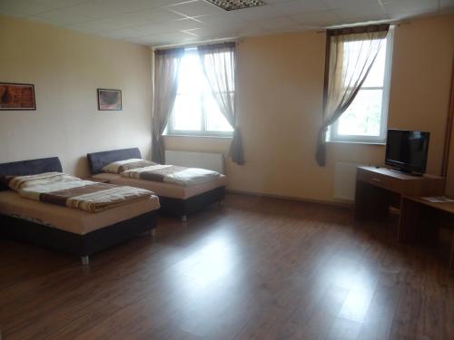 a living room with a couch and a bed and windows at Penzion 324 in Štoky