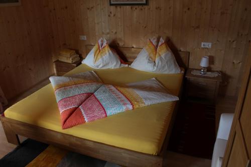 two beds in a room with two pillows on them at Frühstückspension Blasge in Bodensdorf