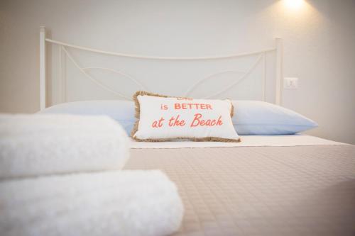 a bed with a pillow that says is better at the bed at Luca's Rooms in Valledoria