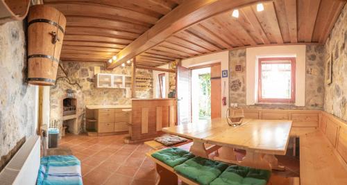 a kitchen with a wooden table in a room at Vineyard Cottage Urban in Mirna