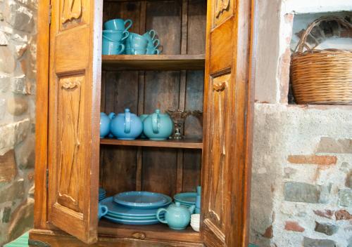 a wooden cabinet with blue cups and dishes in it at Terre Di Himera in Buonfornello
