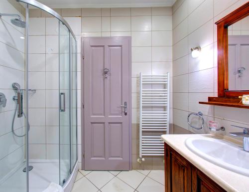 a bathroom with a glass shower and a sink at Hotel Villa Regina in Međugorje
