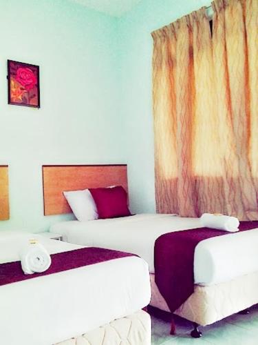 Ένα ή περισσότερα κρεβάτια σε δωμάτιο στο Rose Inn Motel
