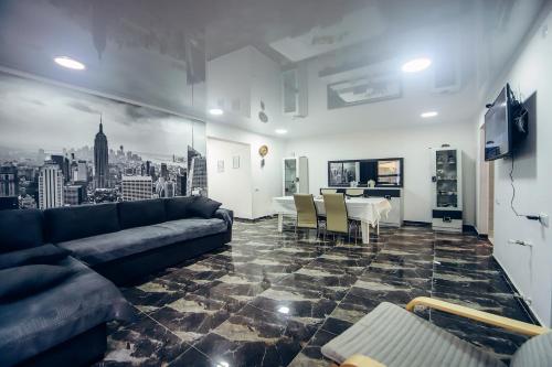 a living room with a couch and a table at Guest House Royal Comfort With Terrace in Kutaisi