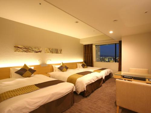 En eller flere senge i et værelse på Hotel Keihan Kyobashi Grande