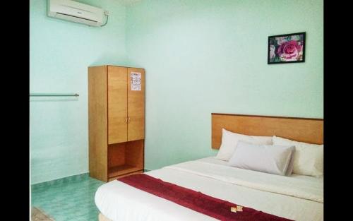 Ένα ή περισσότερα κρεβάτια σε δωμάτιο στο Rose Inn Motel