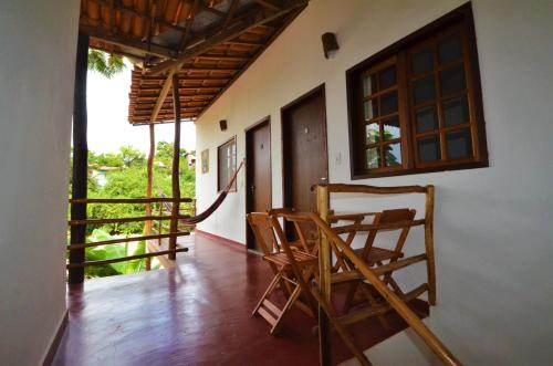a room with chairs and a porch with a window at Doce Lar Hospedaria in Lençóis