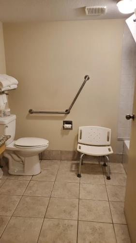 a hospital room with a toilet and a scale at Travelodge by Wyndham Stony Plain in Stony Plain